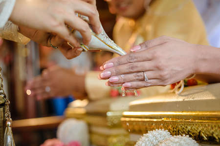 pouring holy water in thai wedding