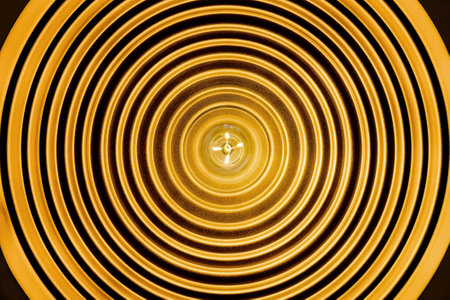 radial line form of ceiling lamp viewed from bottom with bulb at center and black circular line aroundの写真素材
