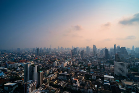 Cityscape photo show traffic jams on the highway of a big city in evening cover by dust mist that made two color skyの写真素材