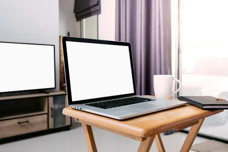 do the working  at home by using laptop on small desk in front of television  at living room in my...