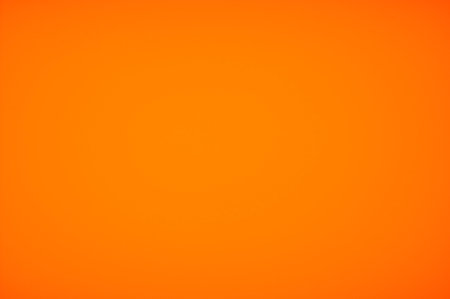a photograph of vivid orange color with conner vignette for used as background wallpaper