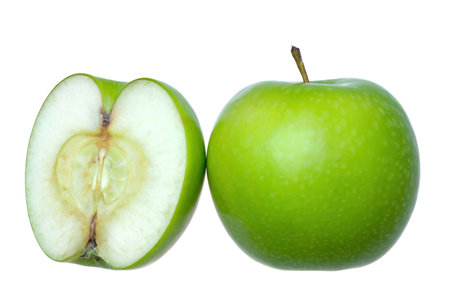 a whole fresh green apple with another half in white backgroundの写真素材