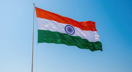 Indian flag waving against clear blue sky on sunny dayの素材