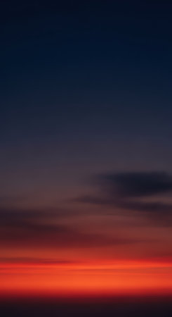 Dramatic sunset with vibrant red and purple sky and dark cloudsの素材