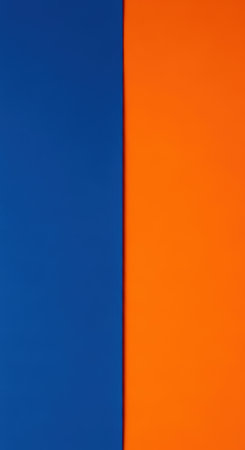 Vibrant contrast of blue and orange backgrounds meeting in harmonyの素材