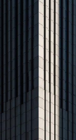 Abstract urban architecture with geometric shadows on skyscraper facadeの素材