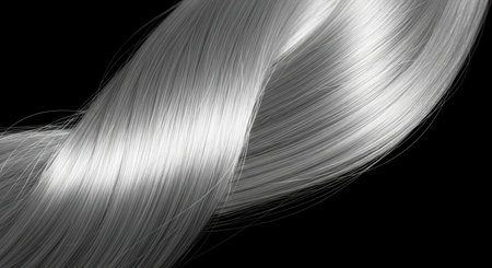 Close-up of silky silver hair strand on black backgroundの素材