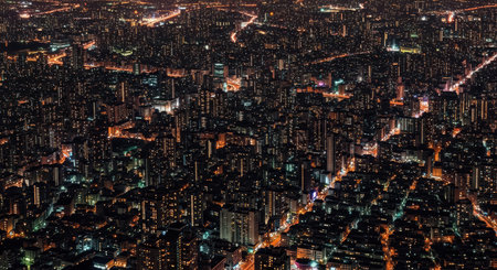 Stunning aerial view of city lights and skyscrapers at nightの素材