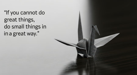 Origami crane with inspirational quote on wooden surfaceの素材