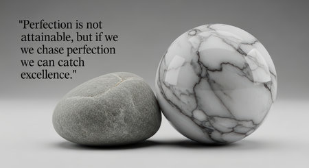 Chasing excellence: smooth stones on gray background with inspirational quoteの素材