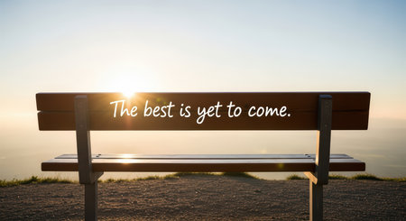 Inspirational sunrise quote on park bench with scenic viewの素材