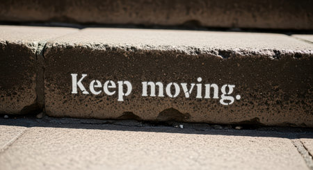 Motivational message on stone step encouraging positivity and forward movementの素材