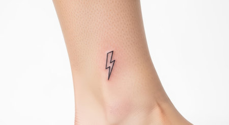 Minimalist lightning bolt tattoo on caucasian female ankleの素材