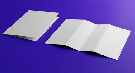 Blank white folded brochures on solid purple backgroundの素材