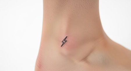 Minimalist lightning bolt tattoo on light skin ankleの素材