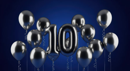 Elegant 10th anniversary celebration with silver balloons on deep blue backgroundの素材