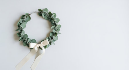 Simple eucalyptus wreath with ivory ribbon on white backgroundの素材