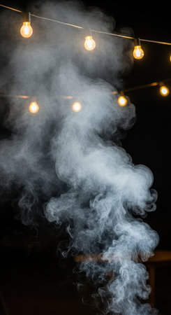 String lights illumine swirling smoke in dramatic night sceneの素材