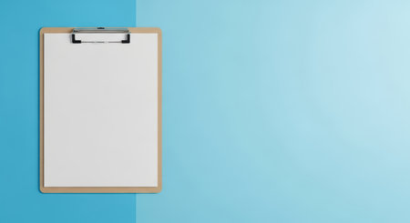 Blank clipboard on blue background for office or school useの素材
