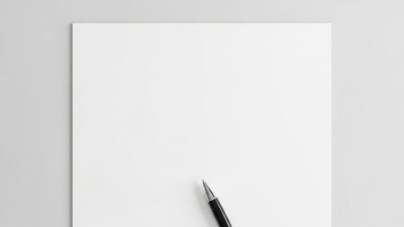 Blank sheet with pen on minimalistic white background for writing or drawing.の素材