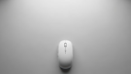 Minimalist white computer mouse on plain gray background.の素材