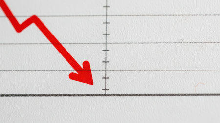 Red arrow decline on financial chart indicating market downturn.の素材