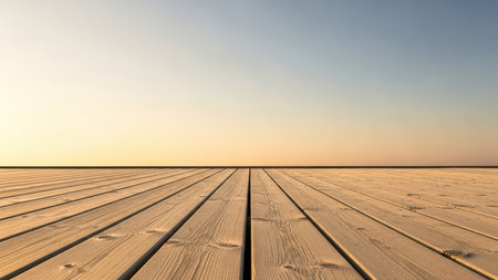 Empty wooden deck with clear sky and horizon at sunrise.の素材