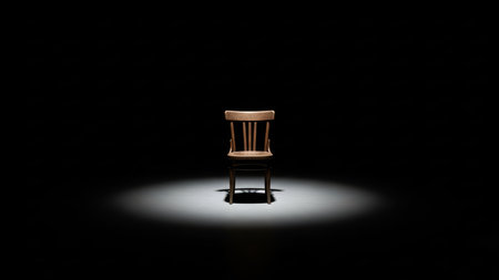 Wooden chair spotlighted on dark stage in empty space.の素材