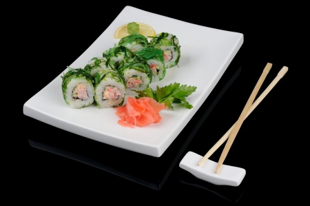 Rolls in green pickled seaweed over blackの写真素材