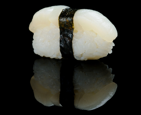 Sea scallop sushi on black reflecting backgroundの写真素材