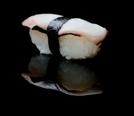 One portion of octopus sushi on blackの写真素材