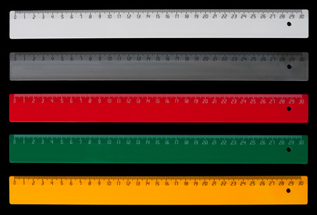Five colorful centimeter rulers isolated on black backgroundの写真素材