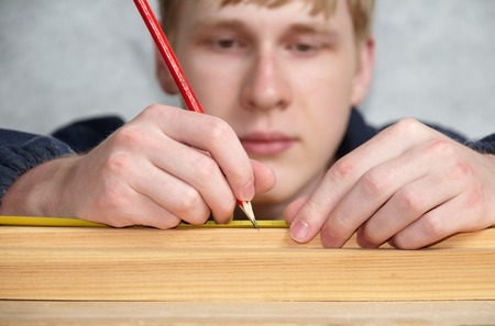 Worker measures distance and puts a markの写真素材