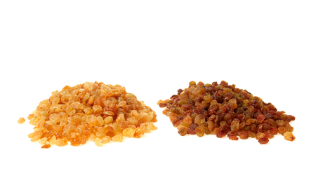 Two heaps of raisins isolated on whiteの写真素材