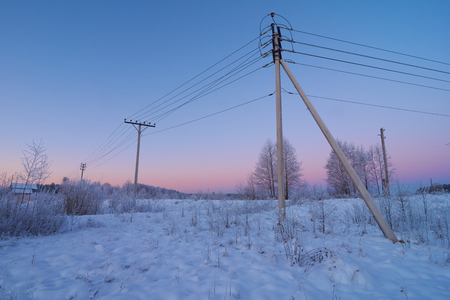 Powerline in the countryside with beautiful crimson sky in the backgroundの写真素材