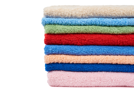 Stack of multicolored terry towels isolated on whiteの写真素材