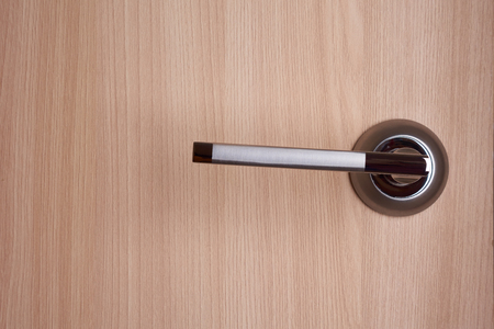 Interior metall door lever on beige doorの写真素材