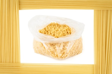 Pasta in open plastic pack framed by capellini (pasta). Food conceptの写真素材