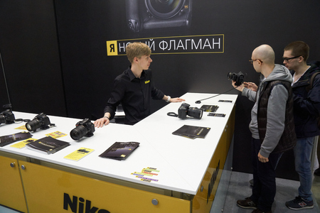 Moscow Crocus Expo, Moscow, Russia - April 15, 2016: Visitors trying Nikon cameras at Nikon Distributor company Photo Sale at Photoforum 2016のeditorial素材