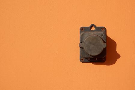 External power outlet on beige wall outdoorsの写真素材