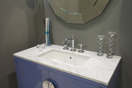 White inset ceramic washbasin with glossy metal mixerの写真素材