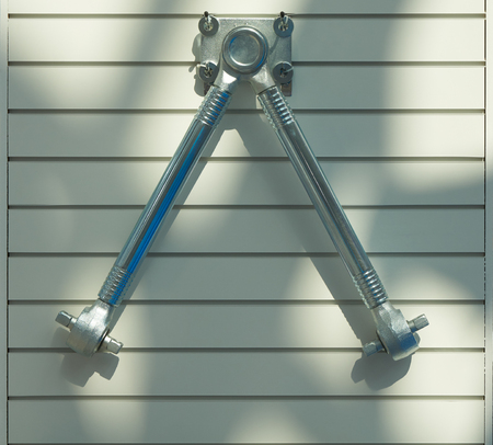 Automobile chassis spare part on the wall. Control armの写真素材