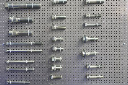 Variety of metal bolts on display on the wall