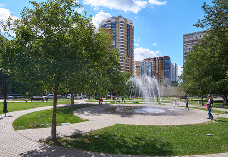 Moscow, Russia - August 08, 2018: Fountain at square with children playing around in summer at Novatorov street in Moscowのeditorial素材