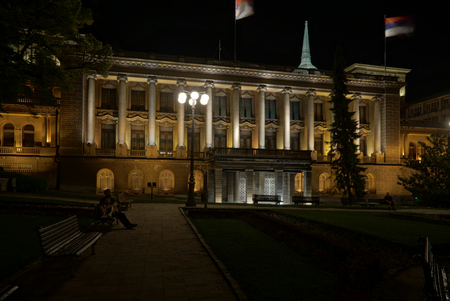 Belgrade, Serbia - May 04, 2018: New palace at night. Young people have rest on the benchのeditorial素材