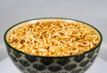 Bowl of noodles, noodle soup in a cup, Asian meal isolated on white backgroundsの写真素材