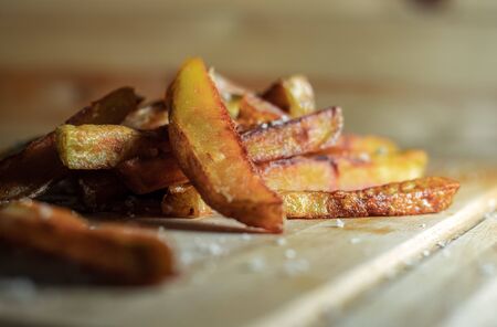 Homemade Salted French Fries On Wooden Background close up