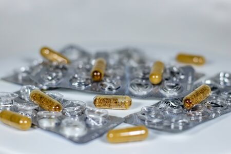 Pharmaceutical medicine, tablets and capsules in white background