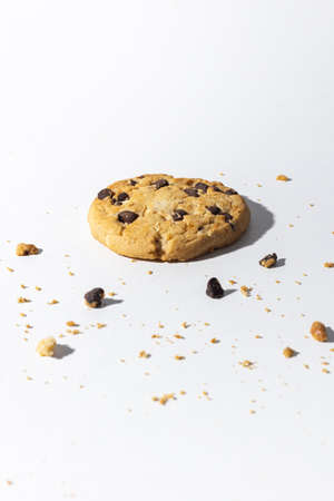 Chocolate chip cookies and crumbs on white backgroundの写真素材