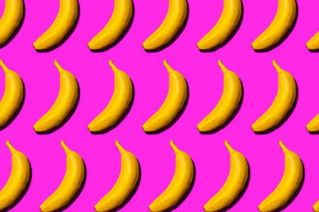 Pattern of fresh yellow bananas on pink background, top view.